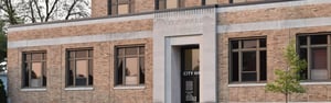 The exterior of a yellow brick building marked 