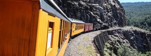 A train driving through the mountains