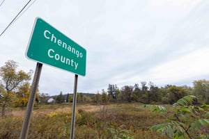 An image of green roadside sign that says 