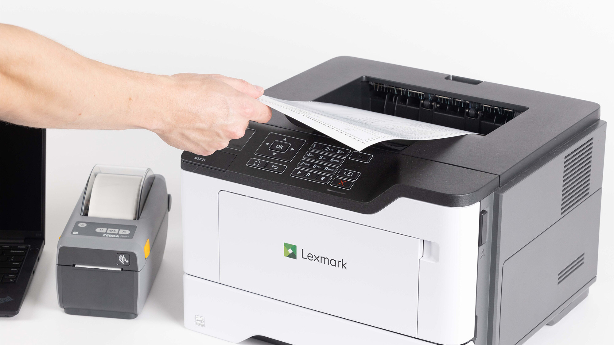 Person pulling paper from printer