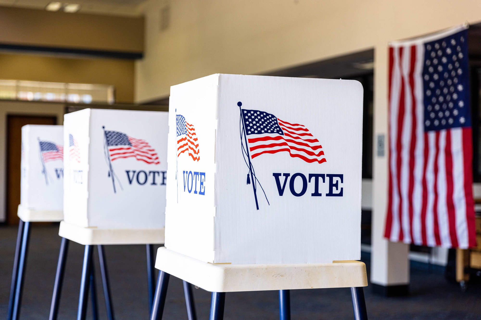 Voting stations that feature a white divider with an American flag and the word 