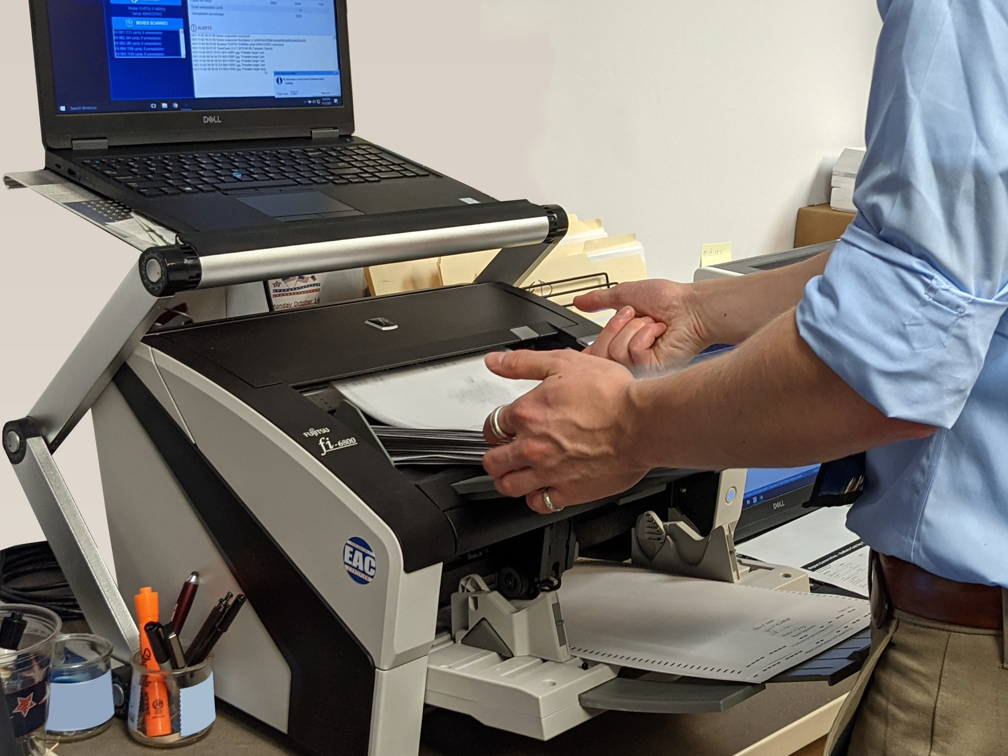 person scanning ballots