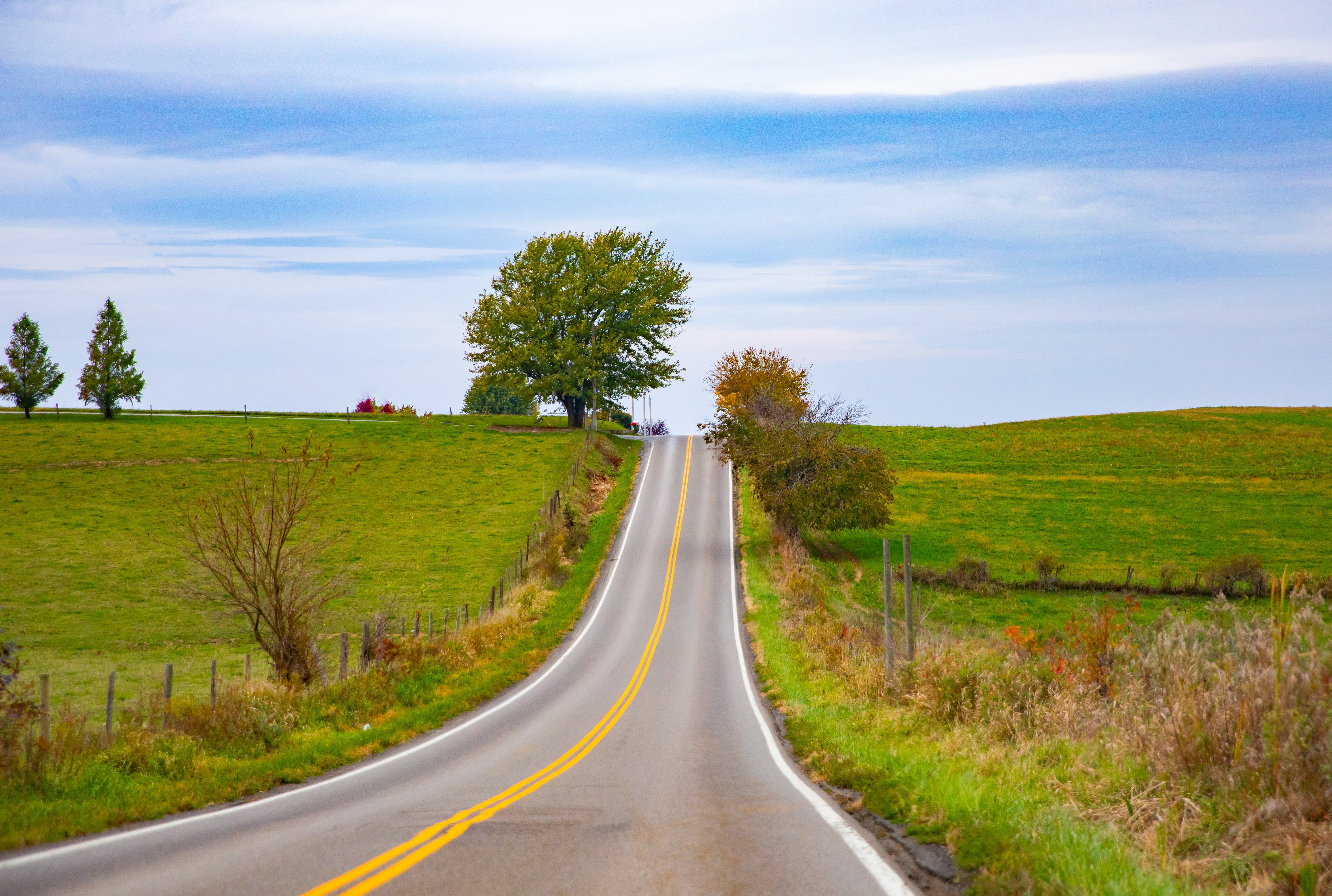 an-empty-road-in-beautiful-countryside-with-green-2022-11-10-08-52-18-utc